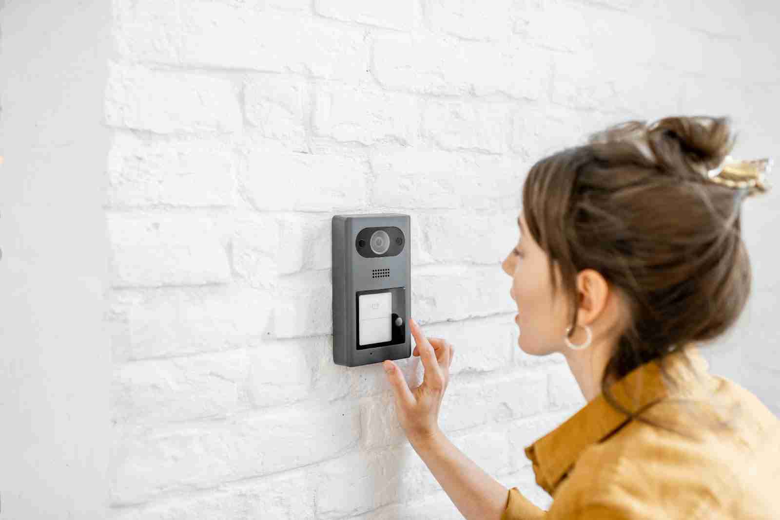 Woman ringing video doorbell